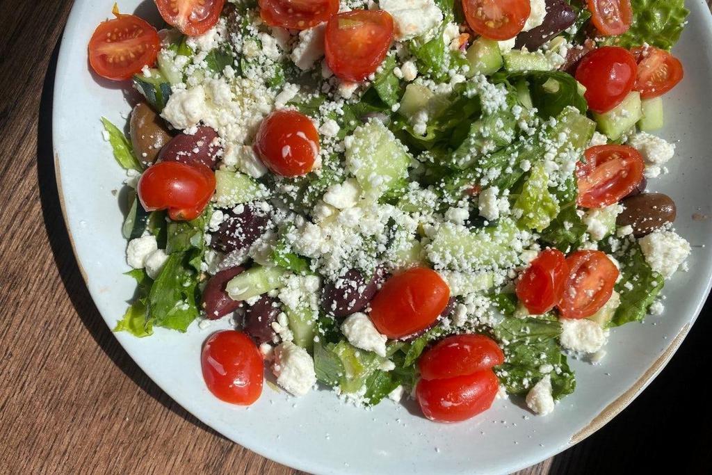 Greek Salad · Romaine, Artichokes, Feta, Tomato, Red Onion, Kalamata Olives, Cucumbers, Greek Dressing