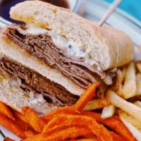 French Dip Sandwich · Thinly Sliced Roast Beef, Carmelized Onions, Horseradish Cream Sauce, and Swiss Cheese, serv...
