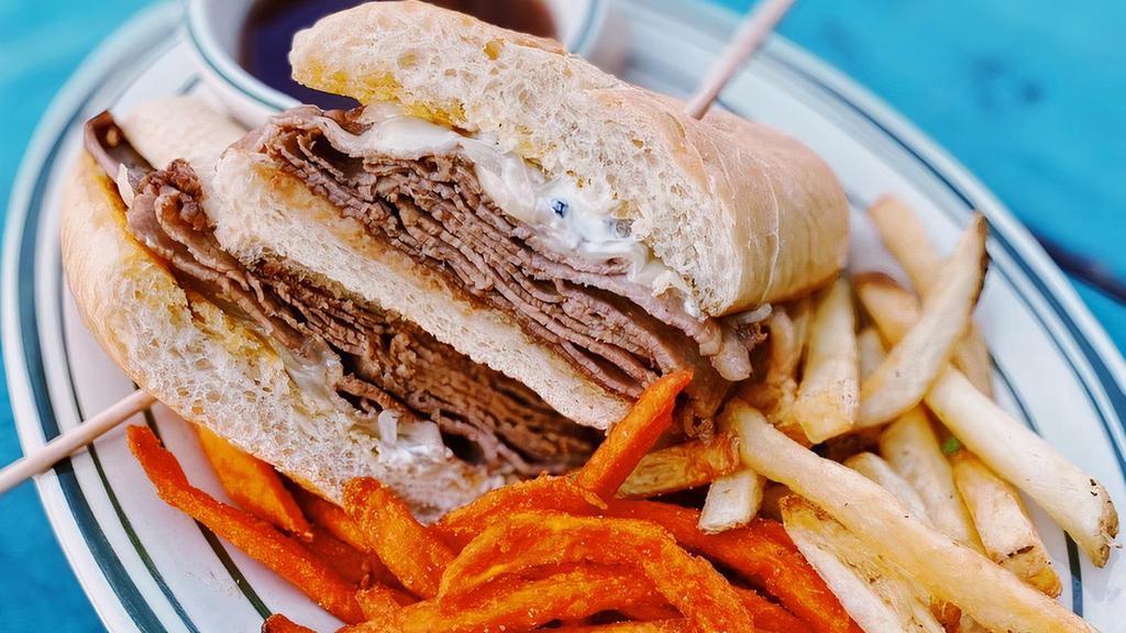 French Dip Sandwich · Thinly Sliced Roast Beef, Carmelized Onions, Horseradish Cream Sauce, and Swiss Cheese, served on a Hoagie Roll with Au Jus