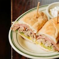 Cuban · Smoked Pulled Pork and Ham, served with Yellow Mustard, Dill Pickle Slices, Big Eye Swiss, a...