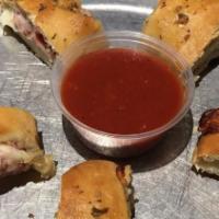 Rollers · Fresh dough rolled out, covered with grated mozzarella cheese and chopped Canadian bacon, th...