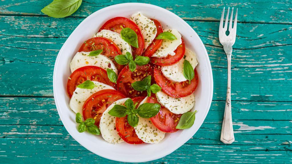 Caprese Salad · Fresh salad prepared with mozzarella cheese, tomato, and basil drizzled with balsamic vinaigrette and sprinkled with salt and pepper.