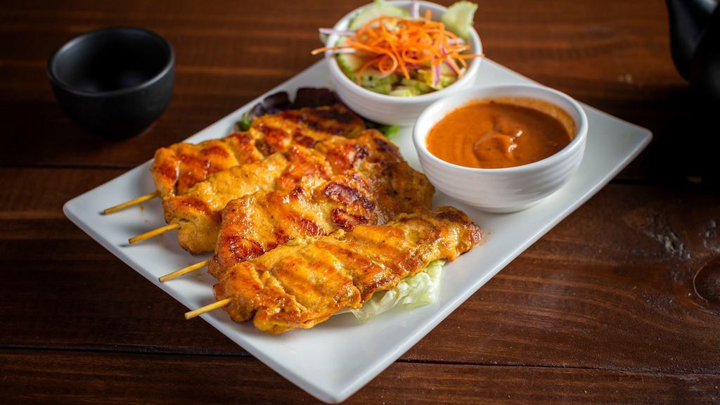 Gai Satay (Grilled Chicken Skewers) · Curry marinated grilled chicken skewers. Served with a side of peanut sauce and cucumber salad. (4 pieces)
