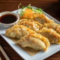 Chicken Pot Stickers · Wonton skin wrapped dumpling filled with ground chicken, cabbage, and onions. Served with a ...