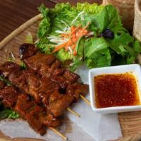 Moo Ping (Grilled Bbq Pork) · Barbeque marinated grilled pork skewers. Served with a side of sweet chili soy sauce mixed w...