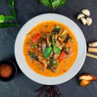 Red Curry · Spicy. Red curry paste blended with spices and coconut milk. Cooked with basil leaves, eggpl...