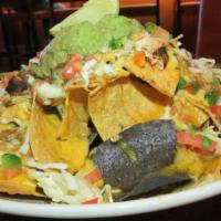 Aztec Nachos · Hot. Wood-grilled blackened chicken, Aztec spicy creamy curry sauce, melted jack, and chedda...