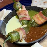 Bacon Wrapped Jalapeños · flash fried jalapeños, jack cheese, garlic, shallots, bacon wrapped, queso, red, green salsas
