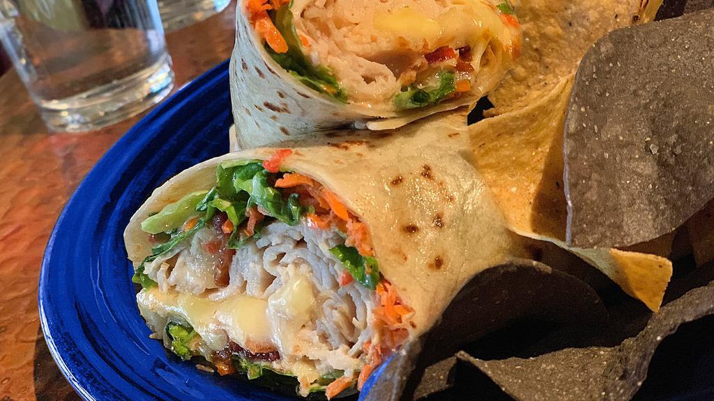 New Mexico Club · Smoked turkey, jack cheese, lettuce, carrots, bacon and sun-dried tomato mayo wrapped in a flour tortilla, served with chips.