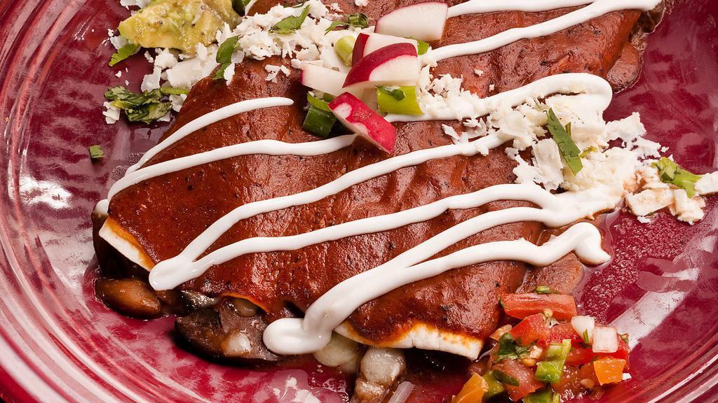 Steak & Mushroom Enchilada - Dinner Portion · tender brisket, rich mushroom stew, ancho chile sauce, jack cheese, cowboy beans, red rice.