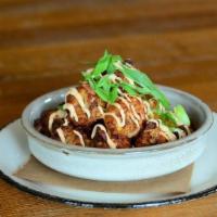 Housemade Loaded Tater Tots · Shredded Potatoes, Pork Croutons, Cheddar Cheese, Chives & Sriracha Cream