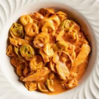 Pollo Tortellini · Tri-colored tortellini noodles stuffed with cheese and joined with strips of grilled chicken...