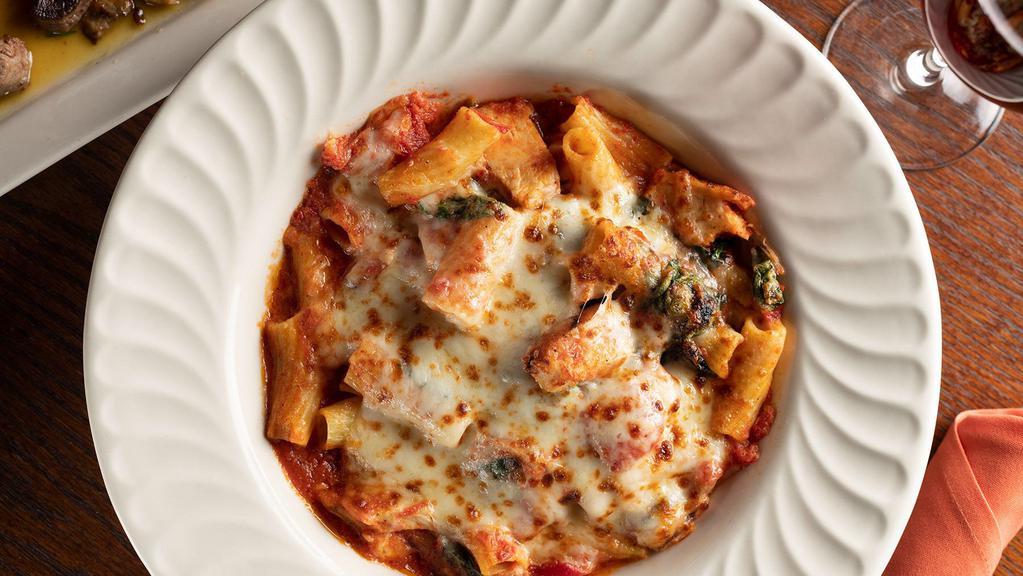 Baked Pollo Rigatoni · Imported rigatoni in a chunky tomato-spinach, olive oil sauce, topped with grilled chicken and Mozzarella cheese.