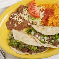 Steak Taco Dinner · Two tacos with sautéed steak topped with lettuce, tomato, and grated Mexican cheese. Served ...