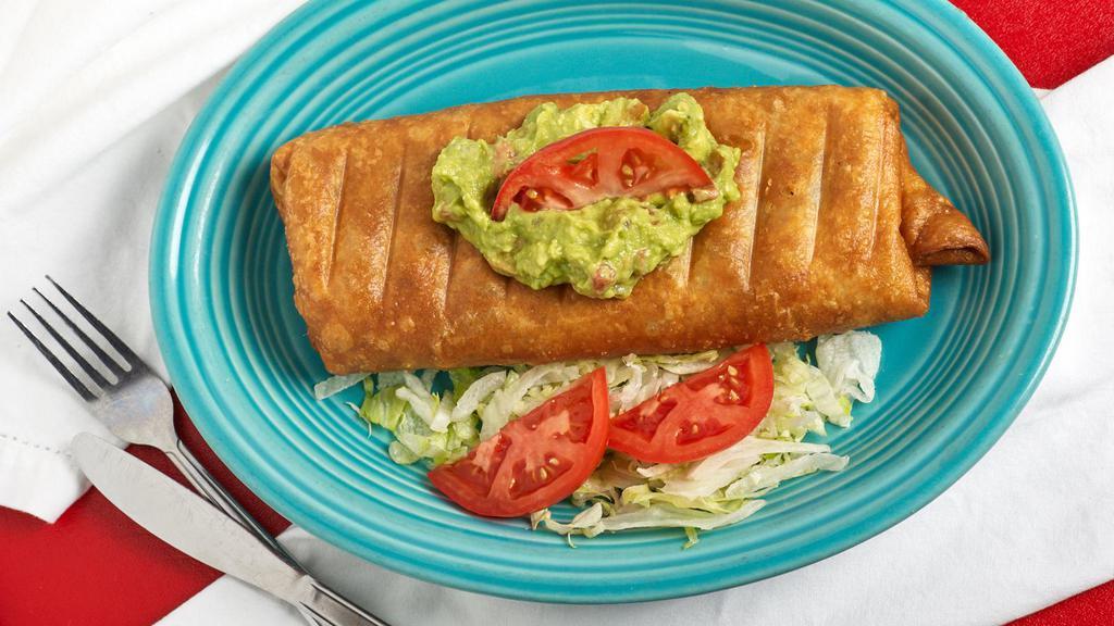 Burrito Frito Dinner · Our regular meat and bean burrito, deep-fried and covered with guacamole and chopped tomatoes.  Served with rice and beans.