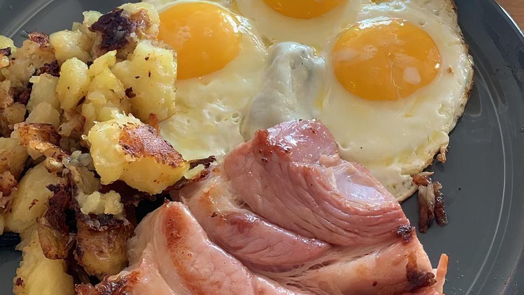 Up North At The Cabin · 3 eggs, 1 slice of Cherrywood bacon, 1 plump lean Jones sausage, hand cut off the bone ham steak. Served with Yukon potatoes.