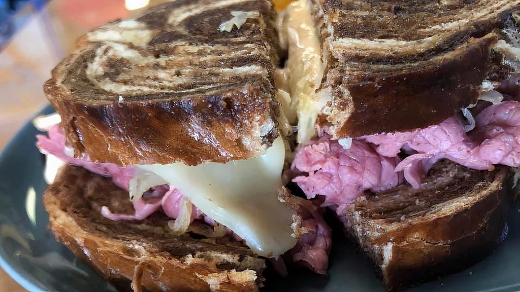 Time Square Reuben · Deli sliced corned beef with robust Swiss & sauerkraut. Our own deli dressing completes this NYC favorite served on grilled marble rye. Choice of potato.