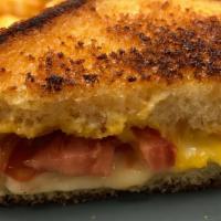 Grilled Cheese For Grown Ups · American & Danish Havarti cheeses buttery grilled on tall egg bread. Served with a hand slic...