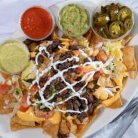 Nachos · Homemade tortilla chips, meat lettuce, tomato, onion, cilantro, jalapeños, sour cream and to...