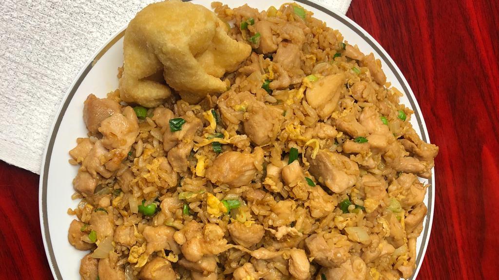 Chicken Fried Rice · Chicken stir fried with scrambled egg , onions and peas then seasoned to perfection with fried rice.