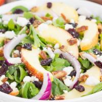Cranberry Pecan Salad · Fresh baby spinach, cranberries, candied pecans, red onion, feta cheese, and cucumbers serve...