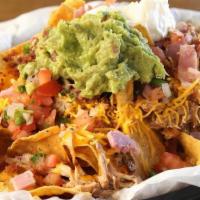 3 Pigs Nacho · Tortilla chips, pulled pork, bacon, ham, cheese sauce, shredded cheddar, guacamole, sour cre...