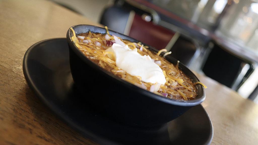Cup Veg Chili · Topped with cheddar cheese, sour cream, onion