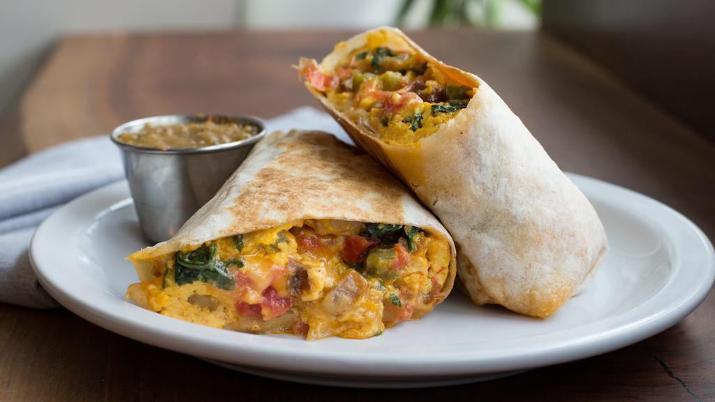 Breakfast Burrito · Choice of meat with scrambled eggs, cheese, spinach, tomato, jalapeno, served with housemade tomatillo salsa.
