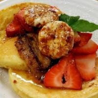 Ricotta Hotcakes · Served with honeycomb butter, caramelized bananas and fresh strawberries.