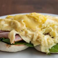 Eggs Benedict · Made with soft scrambled truffle eggs, ham, spinach and tangy hollandaise on an English muff...