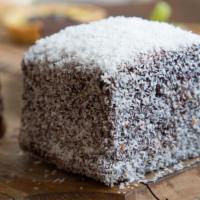 Lamington · An Australian favorite: vanilla sponge cake, with a layer of raspberry jam inside, then dipp...