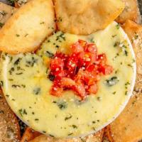 Spinach & Artichoke Dip · Served with seasoned baked pita chips.
