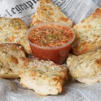 Cheesy Bread · French bread topped with garlic butter, mozzarella cheese, seasoning, and baked.