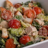 Caesar Salad · Romaine lettuce, tomatoes, and croutons, tossed in a creamy Caesar dressing and topped with ...