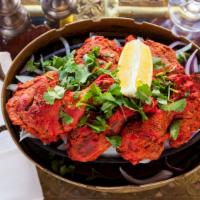 Tandoori Chicken · Chicken marinated in yogurt with freshly ground spices and lemon juice, grilled in a tandoor.
