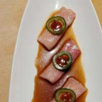 Yellowtail Ponzu · Six pieces of thinly sliced sashimi with ponzu, jalapeños, and chili sauce.