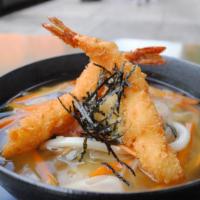 Tempura Udon · Thick white flour noodles in fish broth with shrimp tempura, fish cake & vegetables.