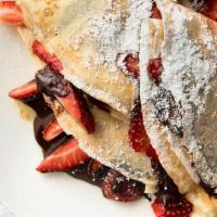 Nutella Crepe · Nutella, strawberry, and banana filled crepe topped with whipped cream, chocolate drizzle an...