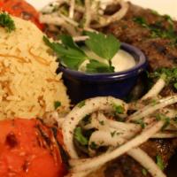 Beef Kaftah · Grilled seasoned ground beef with onion, tomatoes, parsley and tahini sauce.