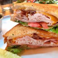 Smokin’ Club Grill · Smoked ham, turkey, bacon, cheddar, lettuce, tomatoes and chipotle mayo on thick sliced toast.