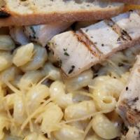 Smoked Gouda Mac-N-Cheese · Cavatappi pasta with a creamy smoked Gouda cheese sauce. Picture shown with Chicken added!