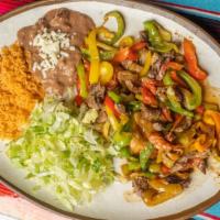 Fajitas Dinner · Fajitas served with bell pepper, tomatoes, onion, rice and beans and tortillas.