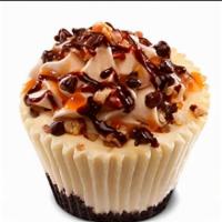Turtle Cheesecake · Turtle cheesecake topped with caramel buttercream, sprinkled with pecans and chocolate chips...