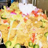Half Order Nachos · Corn tortilla chips with melted Colby jack cheese, lettuce, tomatoes, onion, olives, jalapen...