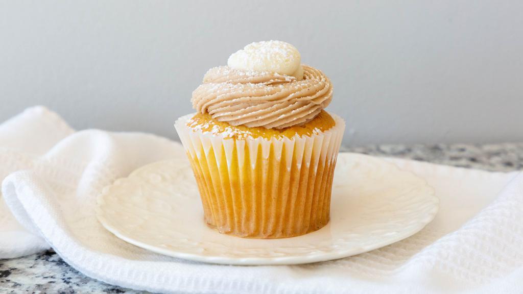 Stuffed French Toast · Vanilla cupcake filled with cream cheese icing and topped with a swirl of maple cinnamon buttercream and vanilla buttercream and a sprinkling of powdered sugar.