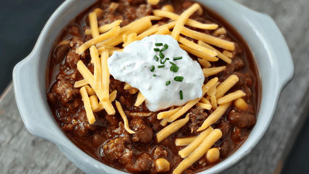 Bison Chili · Ground bison, chili beans, roasted corn & peppers, garnished with cheddar & sage crema. (cal 620)