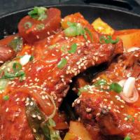 Braised Spicy Pork Ribs · Braised pork ribs cooked with spicy chili sauce (gochujang), daikon radish, potato, onion, z...