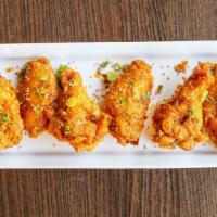 Asian Wings · Flash fried wings tossed in an Asian glaze sauce, topped with sesame seeds (6pc)