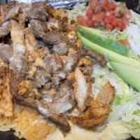 Parrillada · Michelada. Grilled Angus steak, chicken and chorizo with onions. Served over rice and cheese...