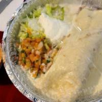 Azteca Burrito · Filled with Angus ground beef, shredded chicken, rice and beans. Topped with cheese sauce or...